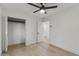 Bright bedroom featuring light wood floors, a modern ceiling fan and a closet at 7607 E Charter Oak Rd, Scottsdale, AZ 85260