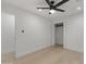 Bright bedroom featuring wood-look floors, a modern ceiling fan and a closet at 7607 E Charter Oak Rd, Scottsdale, AZ 85260