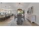 Bright dining room featuring a modern table set with seating for six, stylish rug, and decorative cabinet at 7607 E Charter Oak Rd, Scottsdale, AZ 85260