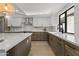 Modern kitchen design with stainless steel appliances, marble backsplash, and light wood flooring at 7607 E Charter Oak Rd, Scottsdale, AZ 85260