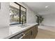 Modern kitchen sink with black fixtures and view of the pool area at 7607 E Charter Oak Rd, Scottsdale, AZ 85260