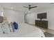 Spacious main bedroom featuring a king bed, ceiling fan, and wood floors at 7607 E Charter Oak Rd, Scottsdale, AZ 85260