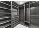 Spacious walk-in closet with gray shelving and drawers providing ample storage at 7607 E Charter Oak Rd, Scottsdale, AZ 85260