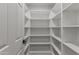 Bright, walk-in closet with custom shelving for optimal storage at 7607 E Charter Oak Rd, Scottsdale, AZ 85260