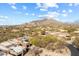 Breathtaking aerial view of a luxury home nestled in a desert landscape and the McDowell mountains in the background at 9221 E Whitethorn Cir, Scottsdale, AZ 85266