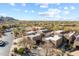 Desert home with the McDowell Mountains in the background with neutral tones, native landscaping, and block construction at 9221 E Whitethorn Cir, Scottsdale, AZ 85266