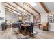 Open-concept dining area featuring wood floors, beamed ceiling and access to the living area at 9221 E Whitethorn Cir, Scottsdale, AZ 85266