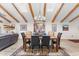 Dining room with beam ceilings, wood floors, area rug and modern chandelier at 9221 E Whitethorn Cir, Scottsdale, AZ 85266