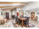 Dining room with wood floors open to the kitchen and living areas at 9221 E Whitethorn Cir, Scottsdale, AZ 85266