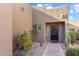 Front entrance with decorative door, desert landscaping and stone pathway at 9221 E Whitethorn Cir, Scottsdale, AZ 85266