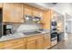 Modern kitchen featuring stainless steel appliances, granite countertops, and light wood cabinetry with sleek hardware at 9221 E Whitethorn Cir, Scottsdale, AZ 85266