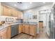 Bright kitchen with stainless steel appliances, granite countertops, window, and wood floors at 9221 E Whitethorn Cir, Scottsdale, AZ 85266