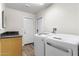 Spacious laundry room with modern washer and dryer, tile floors, and ample storage space at 9221 E Whitethorn Cir, Scottsdale, AZ 85266