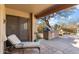 Covered outdoor kitchen with a built-in grill and a lounge chair at 9221 E Whitethorn Cir, Scottsdale, AZ 85266