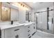 Modern bathroom featuring double sinks, stylish vanities, a glass-enclosed shower, and modern fixtures at 9513 E Hercules Dr, Sun Lakes, AZ 85248