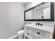 The half bath includes a modern vanity, toilet, and striking patterned tile floors at 9513 E Hercules Dr, Sun Lakes, AZ 85248