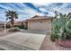 Single-story home with a tile roof and an attached two-car garage featuring well-maintained desert landscaping at 9513 E Hercules Dr, Sun Lakes, AZ 85248