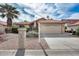 Charming single-story home with a tile roof, palm trees, desert landscaping, and an attached two-car garage at 9513 E Hercules Dr, Sun Lakes, AZ 85248