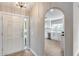 Inviting foyer with decorative glass front door and archway leading to the newly renovated kitchen at 9513 E Hercules Dr, Sun Lakes, AZ 85248