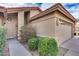 Close-up of a charming single-story home with a tile roof, desert landscaping, and an attached two-car garage at 9513 E Hercules Dr, Sun Lakes, AZ 85248