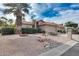 Landscaped front yard with desert landscaping, including rocks and drought tolerant plants, and a palm tree at 9513 E Hercules Dr, Sun Lakes, AZ 85248