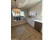 Kitchen nook showcasing a large window, modern lighting, and ample cabinet space at 9513 E Hercules Dr, Sun Lakes, AZ 85248