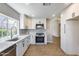 Bright kitchen with stainless steel appliances, white cabinets, and modern countertops for a sleek and functional space at 9513 E Hercules Dr, Sun Lakes, AZ 85248