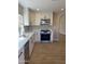 Kitchen featuring stainless steel appliances, quartz counters and white cabinets at 9513 E Hercules Dr, Sun Lakes, AZ 85248