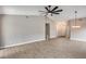 Open living room with wood floors, vaulted ceiling, ceiling fan, and modern chandelier at 9513 E Hercules Dr, Sun Lakes, AZ 85248