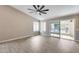 Living room features wood floors, vaulted ceiling, ceiling fan, and access to back patio at 9513 E Hercules Dr, Sun Lakes, AZ 85248