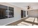 Bright sunroom features wood-look floors, ceiling fan, and sliding glass doors to the outside at 9513 E Hercules Dr, Sun Lakes, AZ 85248