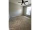 This bedroom features neutral carpeting and a ceiling fan at 10030 W Illini St, Tolleson, AZ 85353