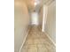 Inviting hallway with beautiful tile flooring, leading to various rooms and the front door at 10030 W Illini St, Tolleson, AZ 85353