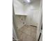 Practical laundry room with tile floors, shelf and door ready for appliances at 10030 W Illini St, Tolleson, AZ 85353