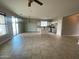 Bright, open-concept living area with tile flooring and white kitchen with island at 10030 W Illini St, Tolleson, AZ 85353