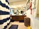 Nautical-themed bathroom with dual vanity, wood cabinets, and decorative blue and white striped shower curtain at 1047 E 9Th St, Mesa, AZ 85203