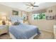 Comfortable bedroom with a tufted headboard, blue bedding, and natural light from the window at 1047 E 9Th St, Mesa, AZ 85203