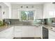 Bright kitchen featuring stainless steel appliances, sleek white cabinets, and ample counter space at 1047 E 9Th St, Mesa, AZ 85203