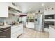 Bright kitchen featuring stainless steel appliances, modern cabinetry, and tile flooring at 1047 E 9Th St, Mesa, AZ 85203