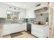 Modern kitchen featuring white cabinetry, stainless steel appliances, and neutral tile backsplash at 1047 E 9Th St, Mesa, AZ 85203