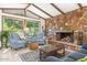 Cozy living room with a stone fireplace, wood-beamed ceiling, and comfortable seating at 1047 E 9Th St, Mesa, AZ 85203