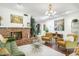 Bright living room featuring a brick fireplace, stylish decor, and hardwood floors at 1047 E 9Th St, Mesa, AZ 85203