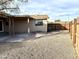 Spacious backyard with desert landscaping, fenced perimeter, and covered patio at 1109 E Emerald Ave, Mesa, AZ 85204