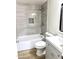 Tastefully renovated bathroom with a modern vanity, tub, and tiled shower at 1109 E Emerald Ave, Mesa, AZ 85204