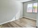 Bedroom with wood-look floors and a window providing ample light at 1109 E Emerald Ave, Mesa, AZ 85204