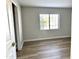 Bedroom with wood-look floors and a window providing natural light at 1109 E Emerald Ave, Mesa, AZ 85204