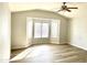 Spacious bedroom with large bay window, ceiling fan, and wood-look flooring at 1109 E Emerald Ave, Mesa, AZ 85204