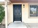 Inviting front entrance featuring a stylish black door and modern exterior lighting at 1109 E Emerald Ave, Mesa, AZ 85204