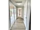 Hallway with wood-look floors leads to a patio slider and other rooms at 1109 E Emerald Ave, Mesa, AZ 85204