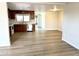 Open-concept living space connecting the kitchen and dining areas with laminate flooring at 1109 E Emerald Ave, Mesa, AZ 85204